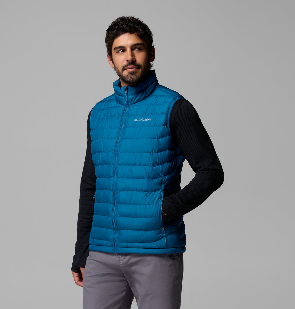 Men's blue quilted puffer vest with zip-front and logo at chest.