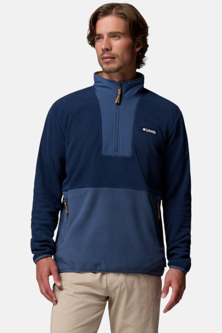 Navy half-zip fleece pullover with stand collar, chest logo, and zip pockets