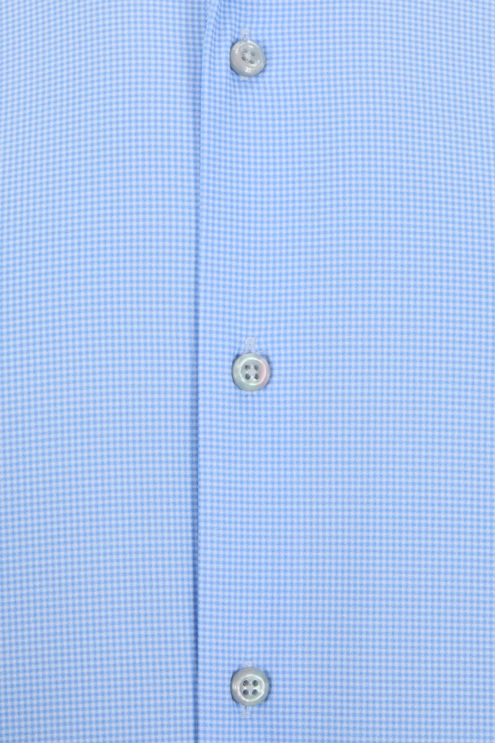 Light blue shirt placket close-up with three visible button details