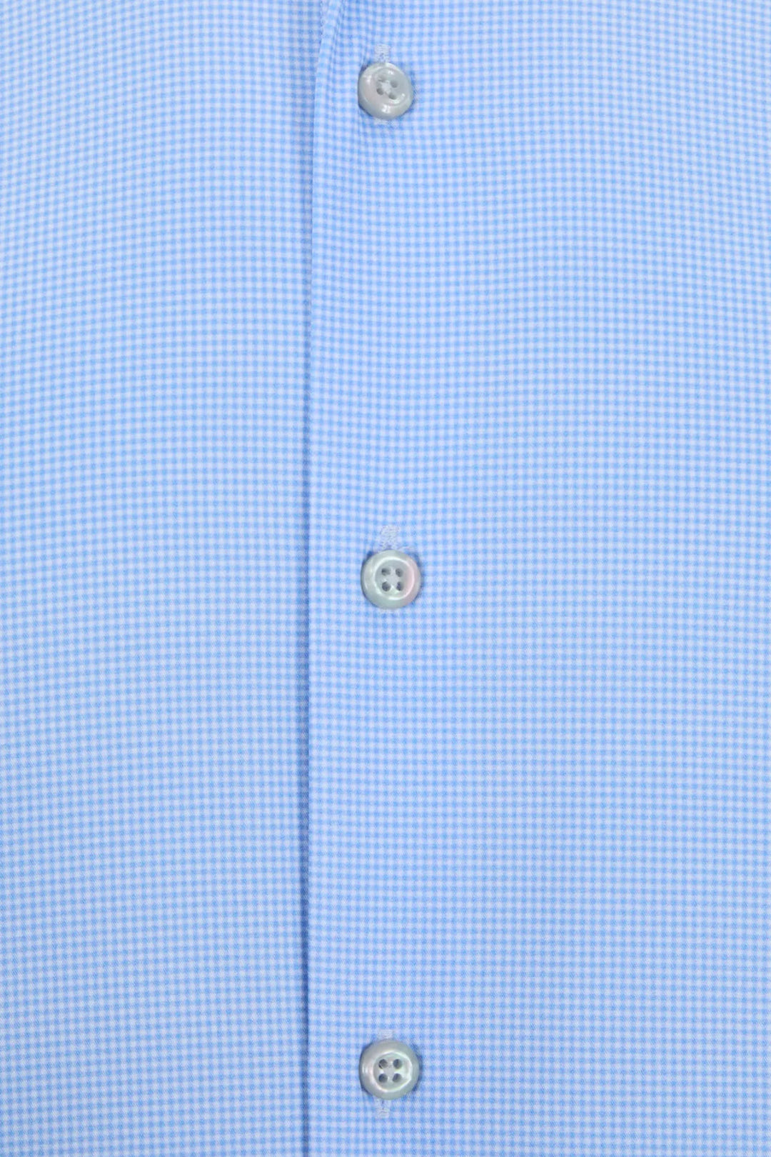 Light blue shirt placket close-up with three visible button details