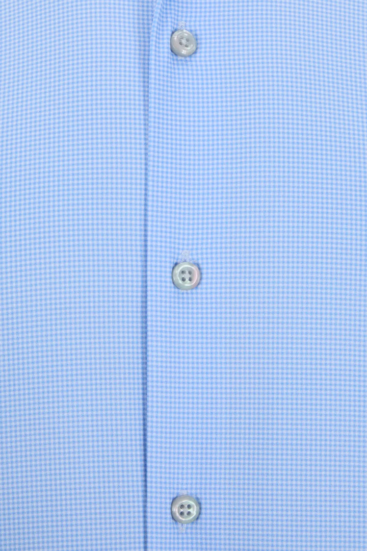 Light blue shirt placket close-up with three visible button details