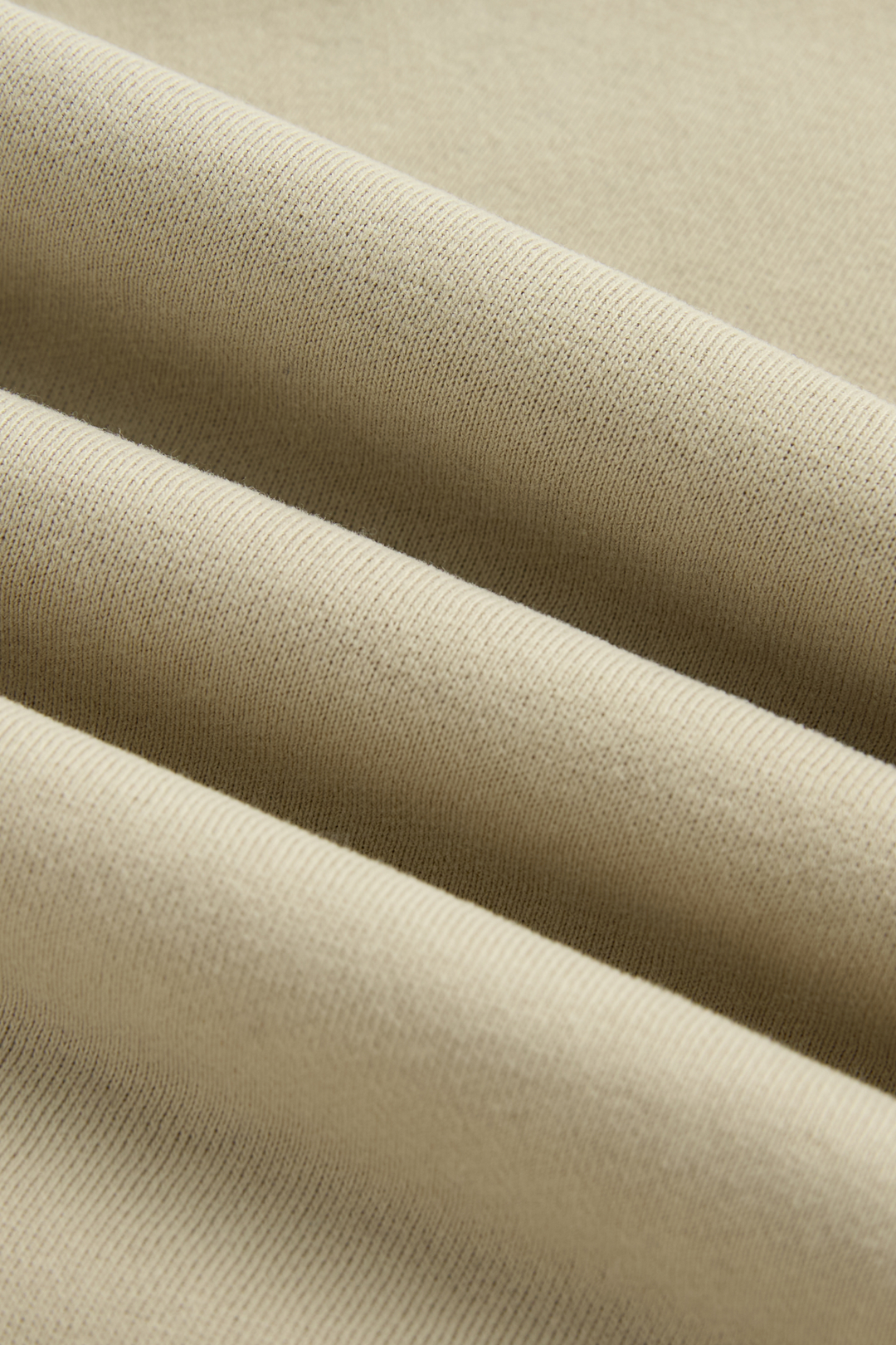 Hoodie fabric close-up showing soft folds and fine knit texture