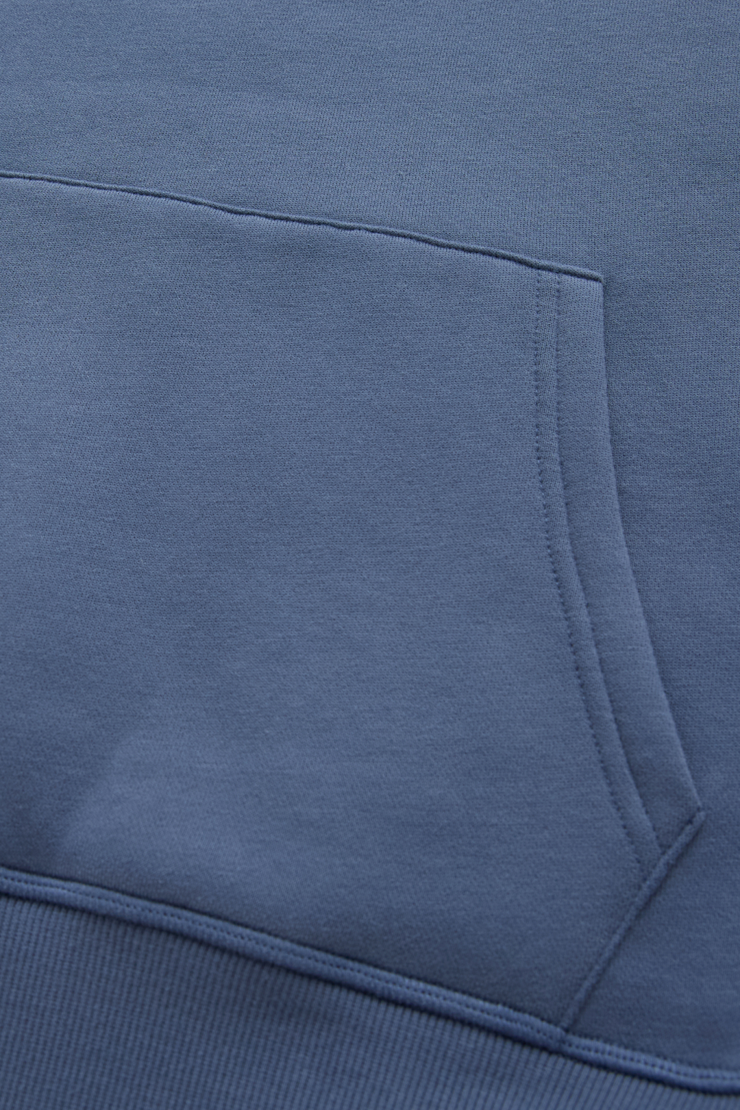 6th Sense hoodie close-up of the kangaroo pocket stitching and blue fabric