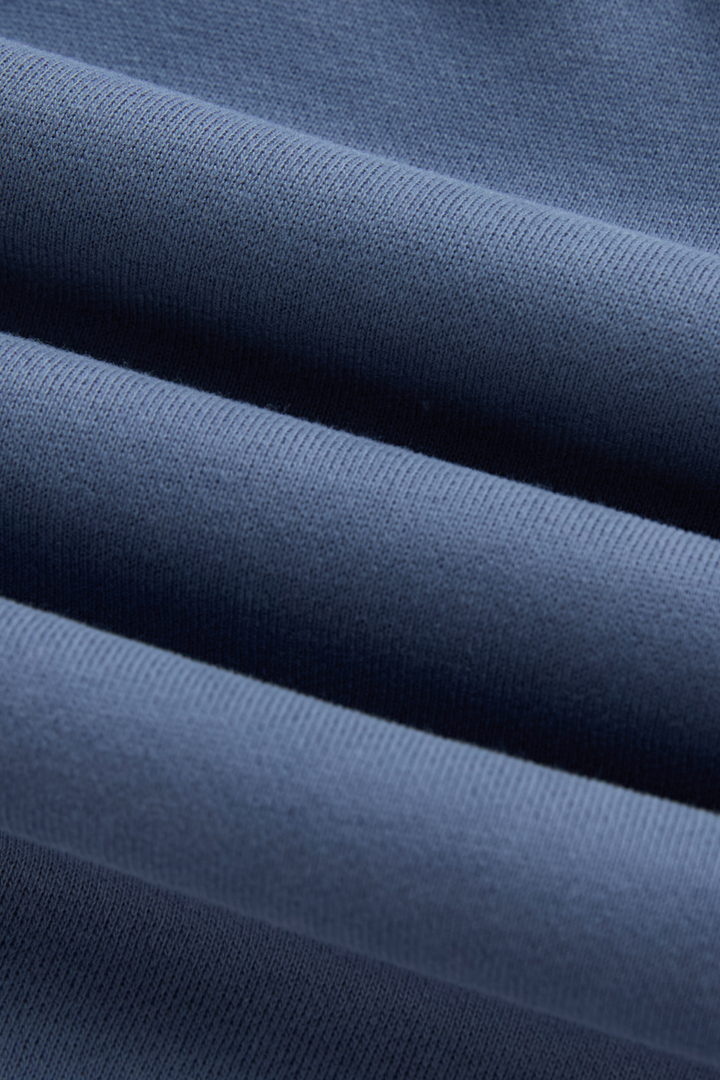 6th Sense hoodie close-up showing the blue knit fabric texture
