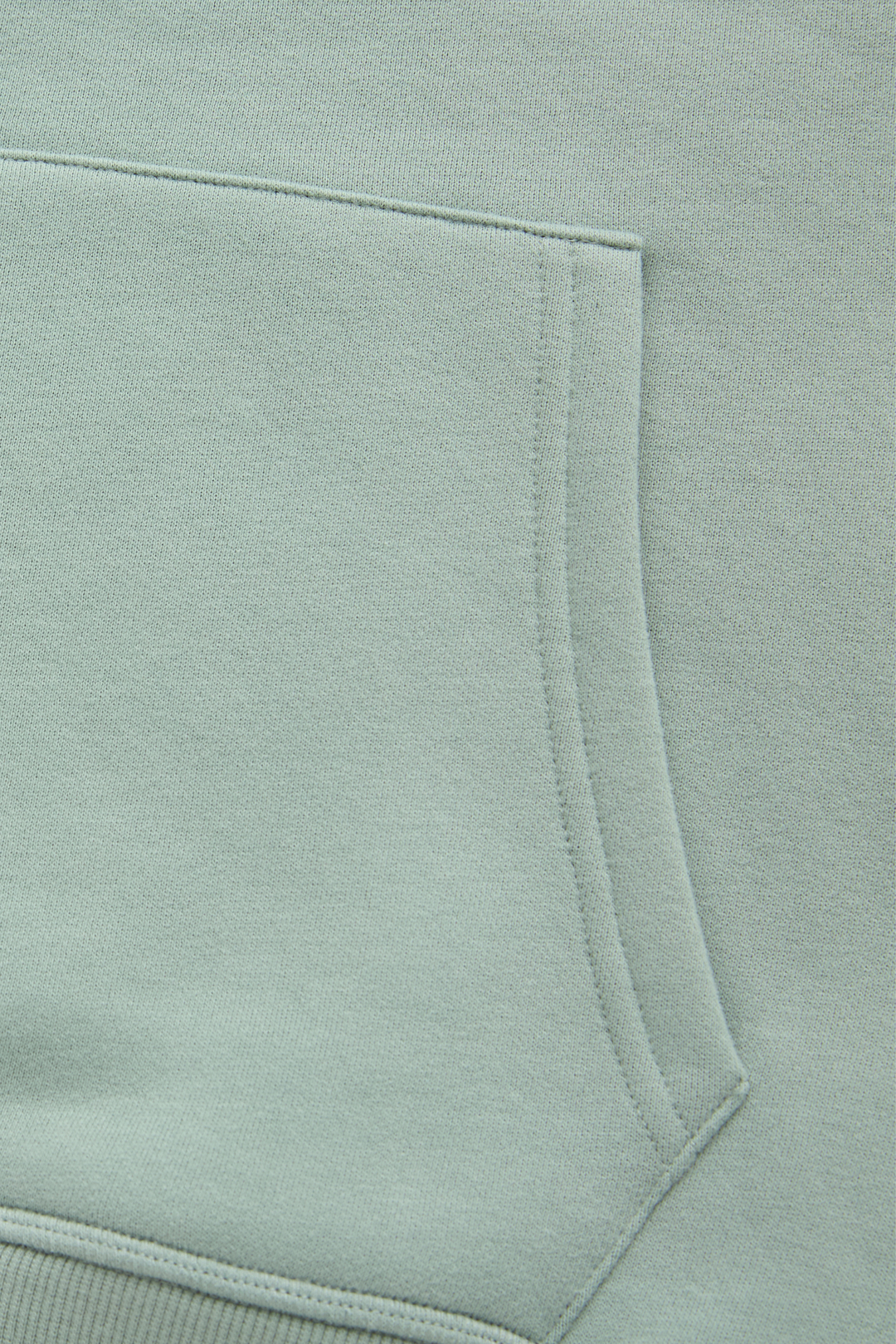 Jade hoodie kangaroo pocket close-up with stitched edging