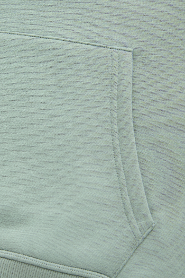 Jade hoodie kangaroo pocket close-up with stitched edging