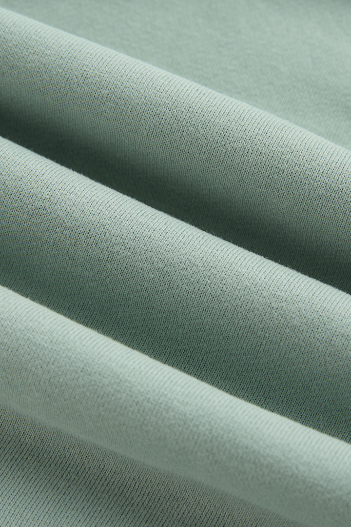 Close-up of the jade hoodie's smooth knit fabric