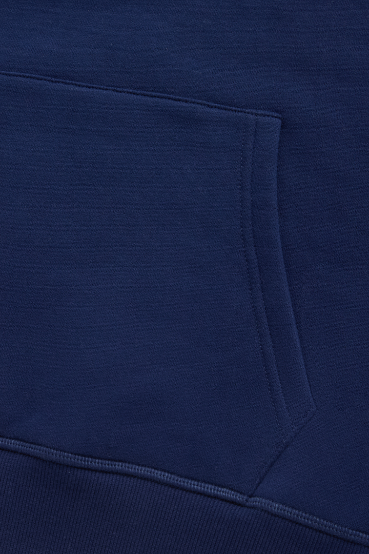 Navy hoodie close-up of the kangaroo pocket and stitched edge