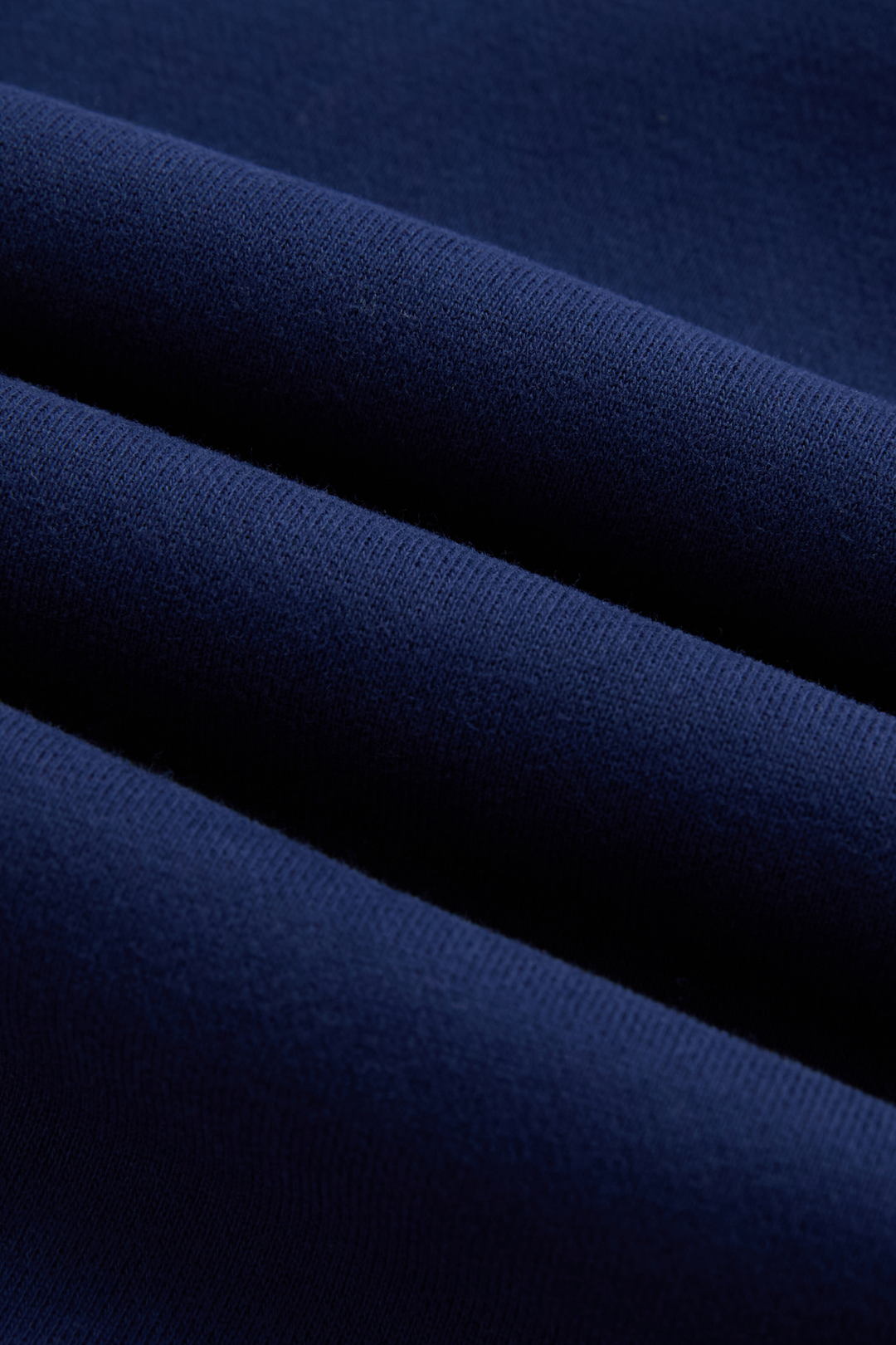 Close-up of the navy hoodie’s textured fabric