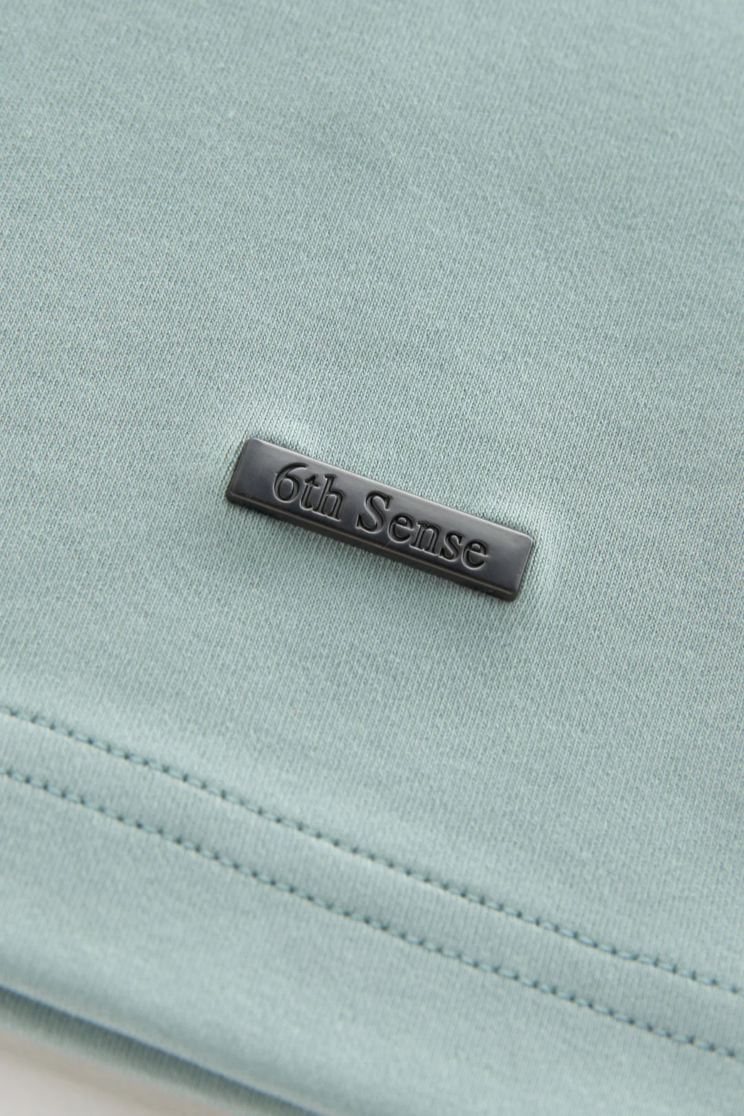 6th Sense woven label on mist green crew neck liquid T-shirt