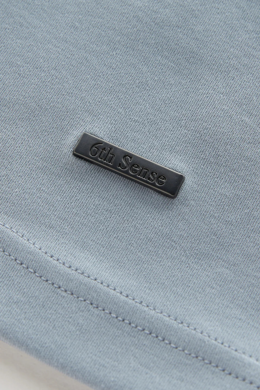 Light blue liquid t-shirt with black 6th Sense fabric label