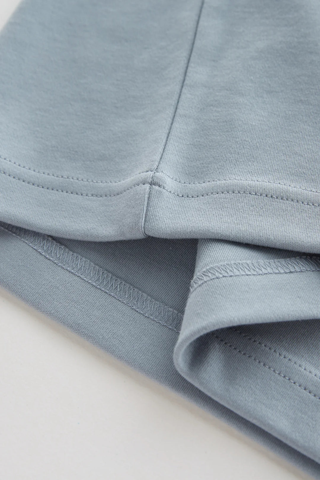 Light blue liquid t-shirt hem and side seam stitching