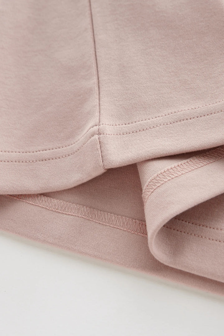 Rose Liquid T-shirt hem and side seam close-up