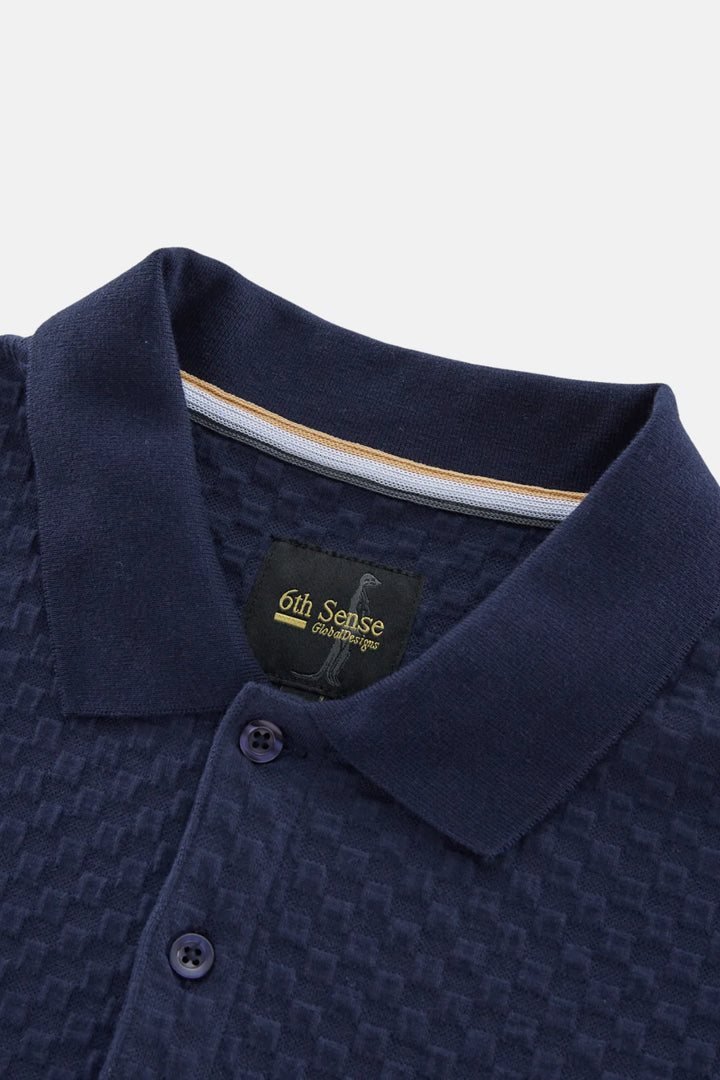 Navy jacquard polo shirt with branded neck label and button placket