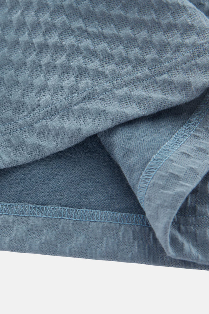 Polo shirt sleeve and hem detail in light blue jacquard fabric