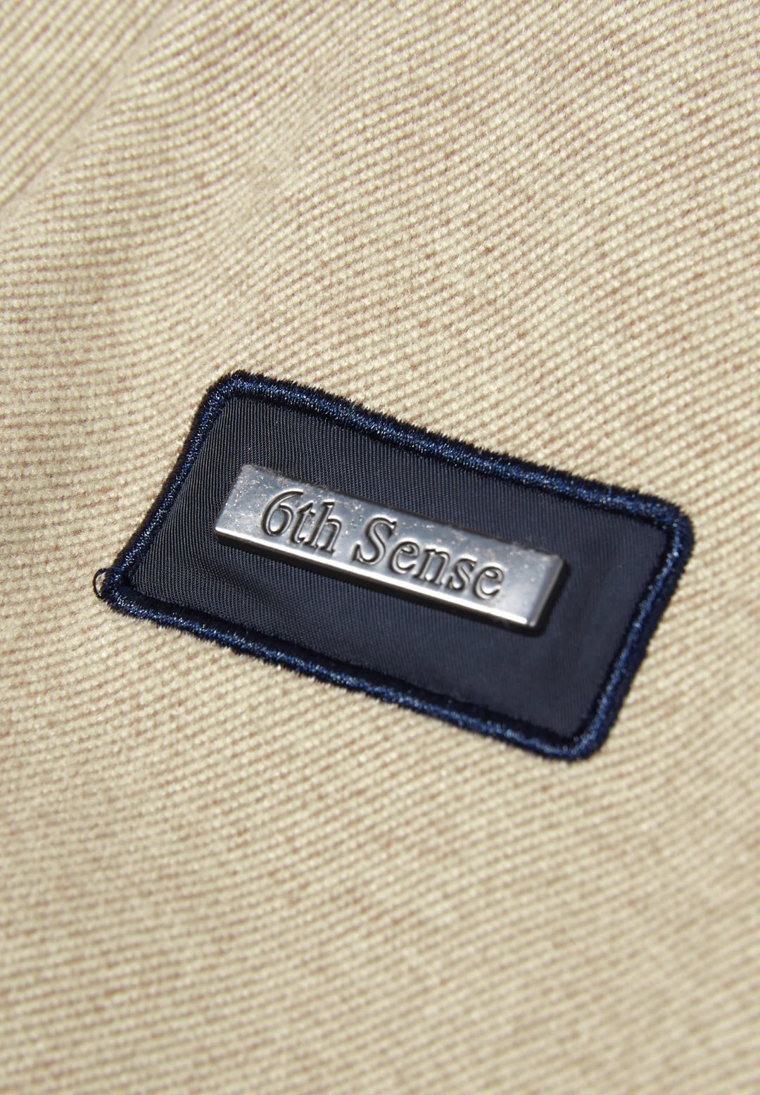 6th Sense logo patch on dark-trimmed neckline of cobblestone 1/4-zip top