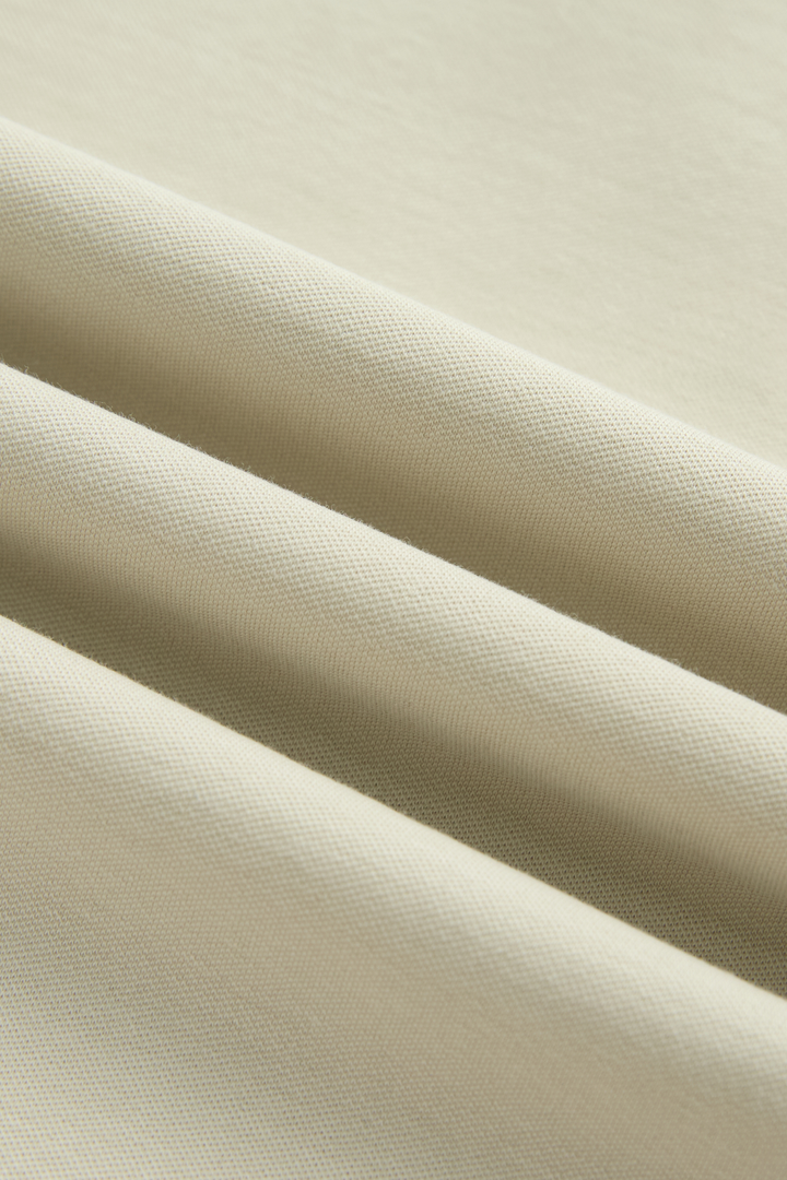 Close-up showing the bone top's fine textured knit fabric