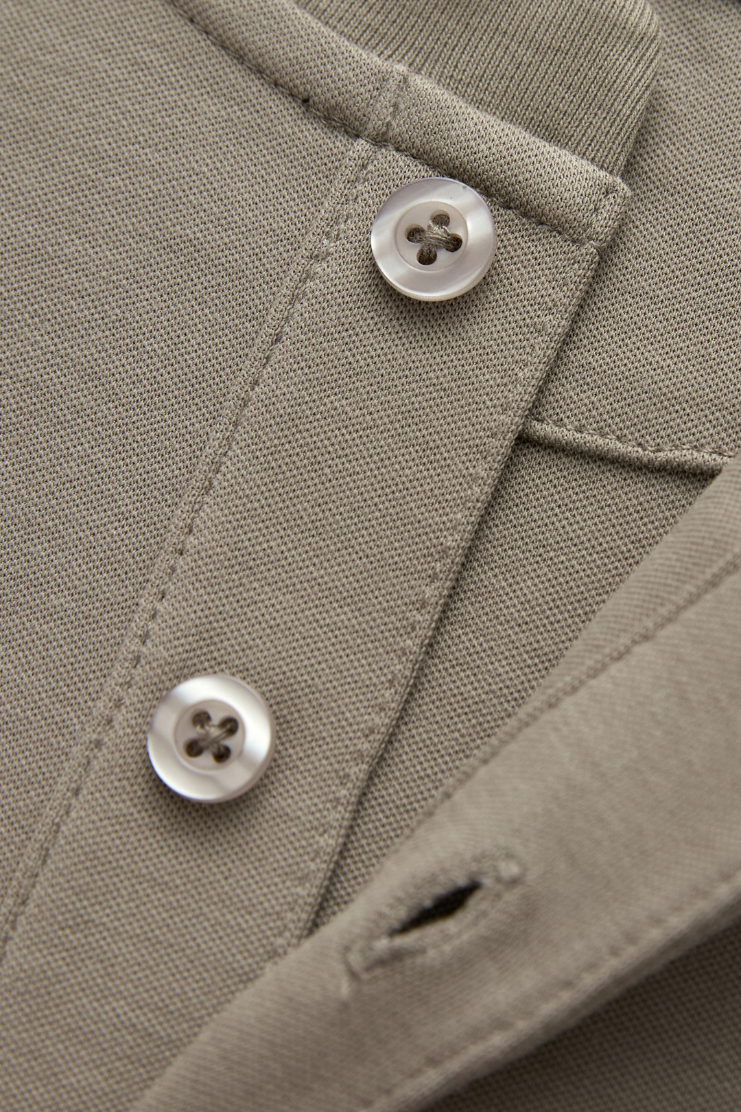 Close-up of the top's textured fabric, button placket, and buttons