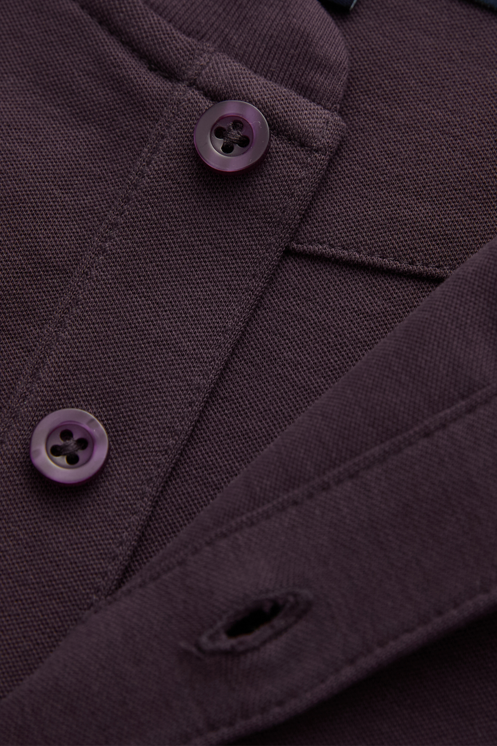 Raisin top detail showing buttons, buttonhole, and textured knit fabric