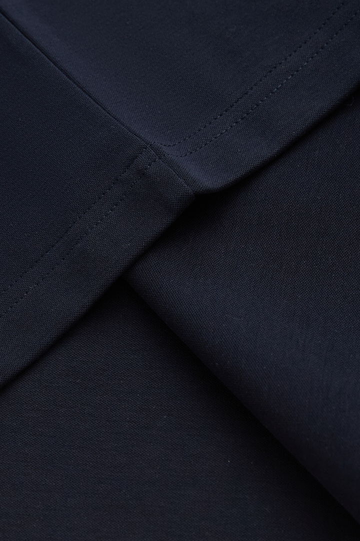Close-up of the top's dark navy fabric and seam stitching