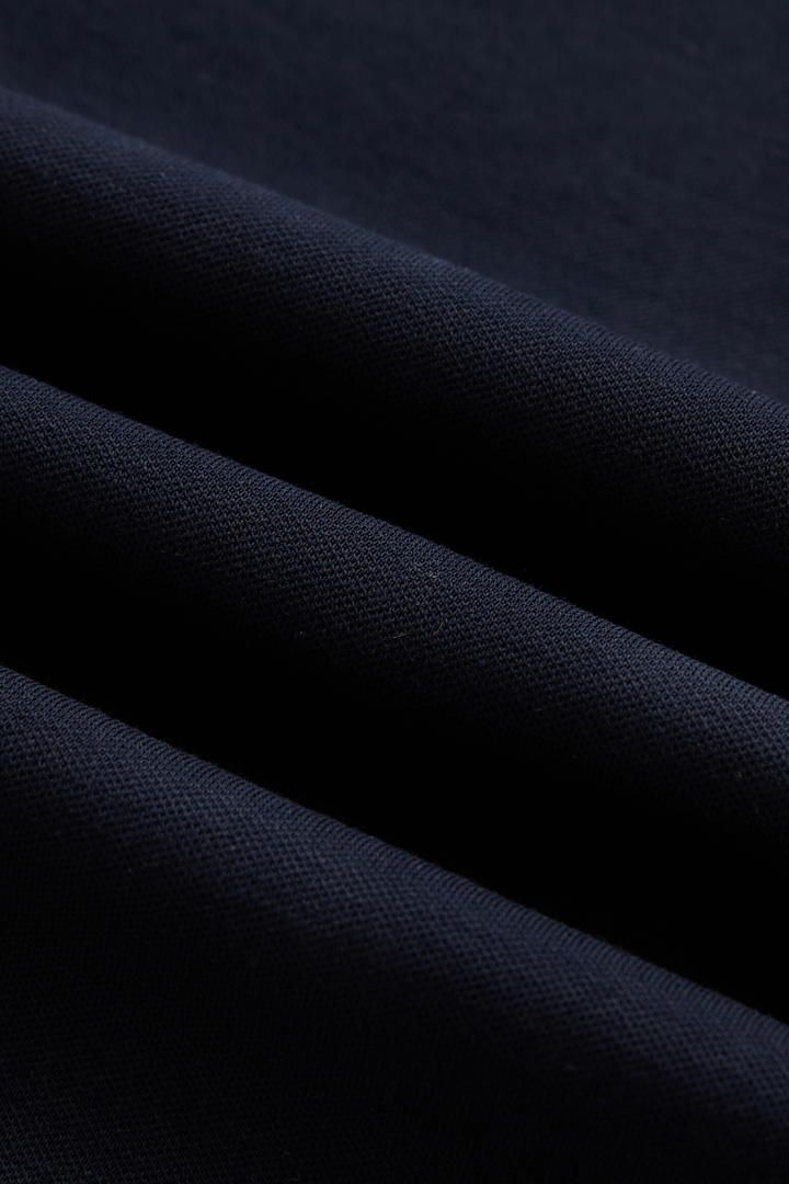 Close-up of the dark navy top's fine textured knit fabric