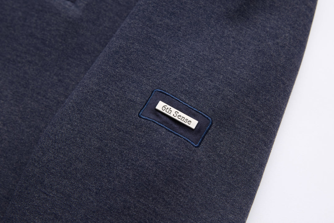 Navy 1/4-zip top with small logo patch on chest