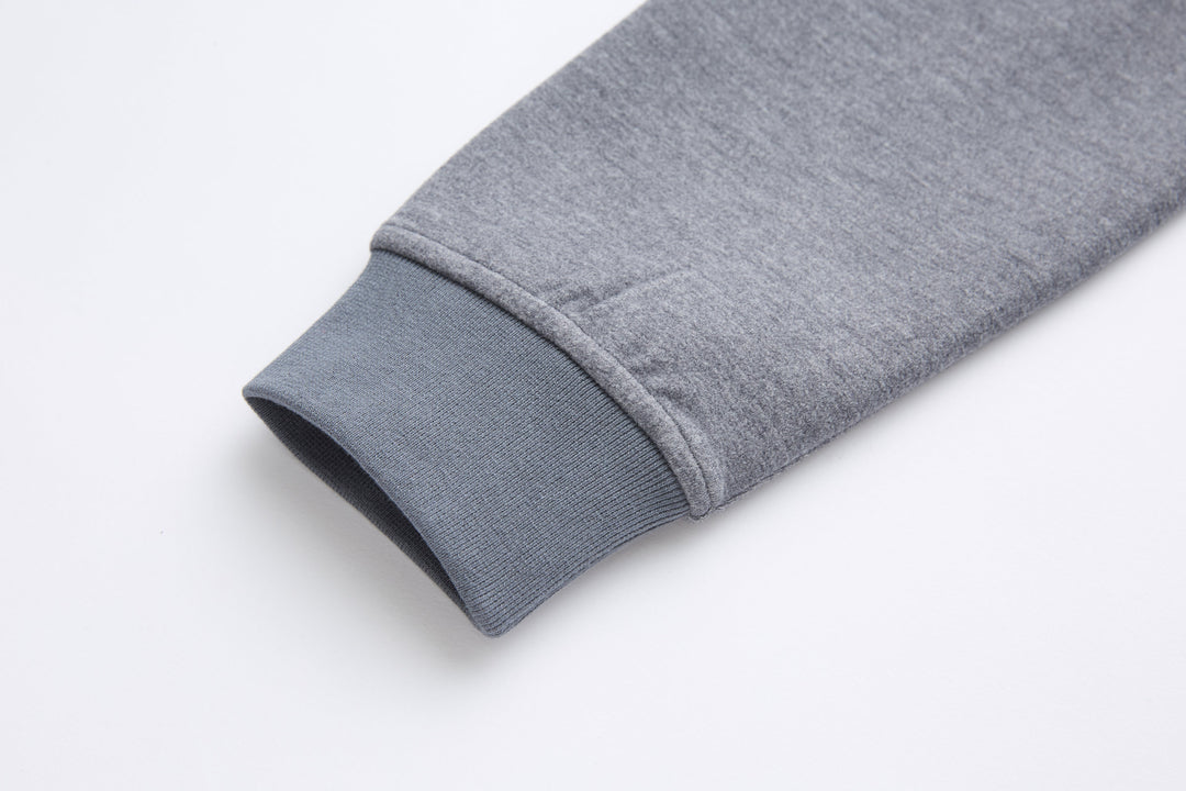 Gray ribbed sleeve cuff at hem of quarter-zip top