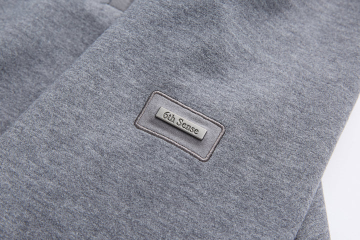 Gray quarter-zip top with 6th Sense logo patch