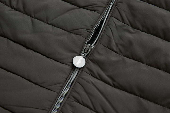 Dark peat gilet zipper close-up with round metal pull