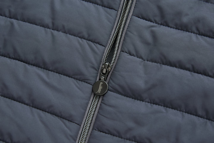 Dark gray-blue gilet front with centered metal zipper and quilted panels