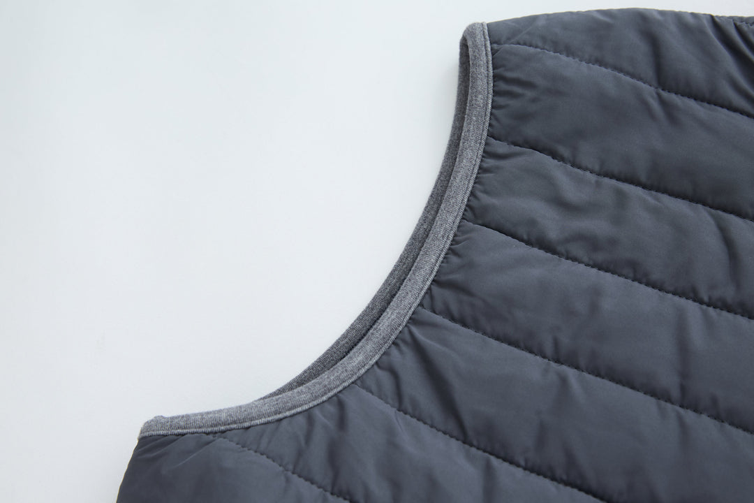 Dark gray-blue sleeveless gilet with bound armhole and quilted yoke