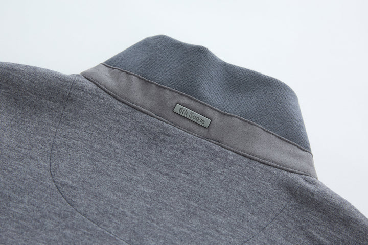 Dark gray-blue gilet back yoke with stitched brand label