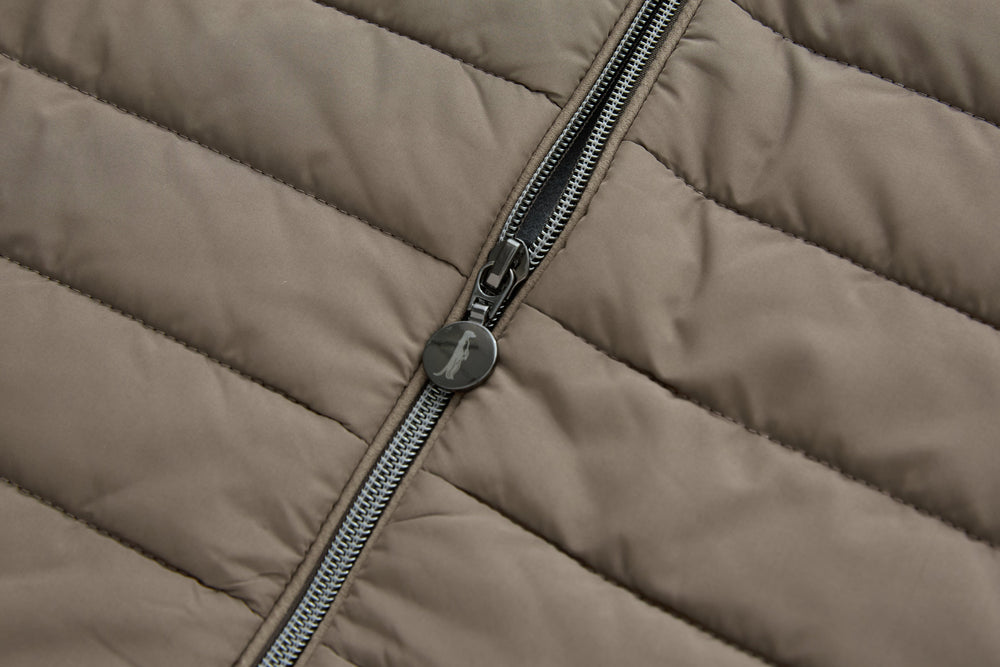 Taupe gilet close-up of center zipper with metal pull and logo tag