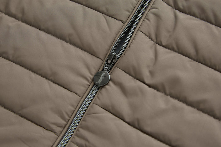 Taupe gilet close-up of center zipper with metal pull and logo tag