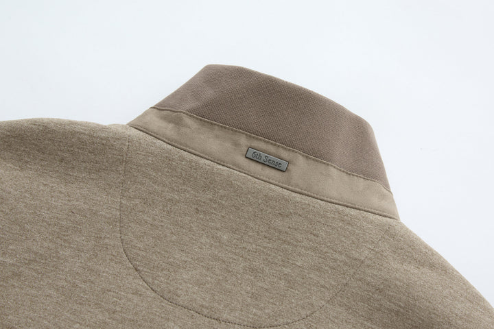 Taupe padded gilet with stand collar and small brand label at chest