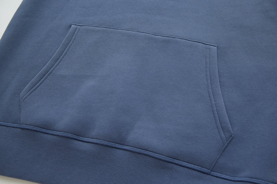 Blue denim hoodie front pocket and stitched panel detail