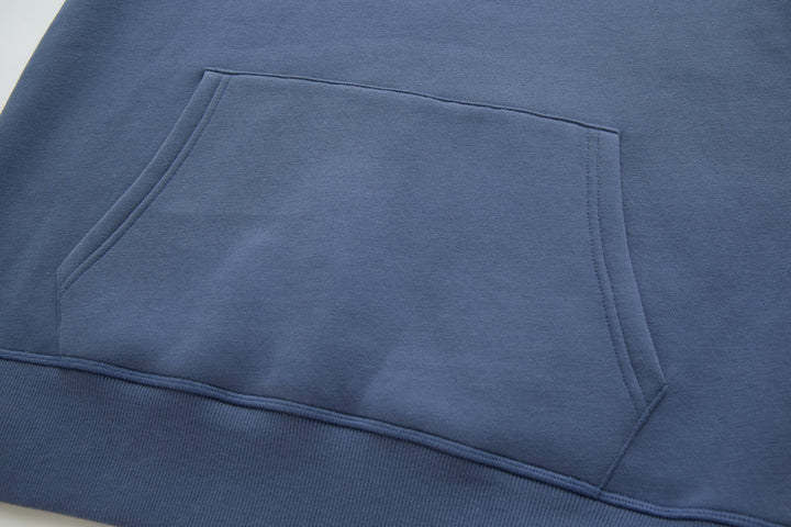 Blue denim hoodie front pocket and stitched panel detail