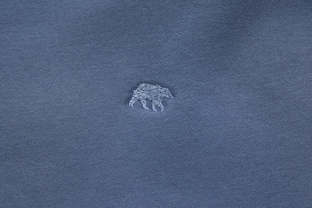 Blue denim hoodie chest logo embroidery detail