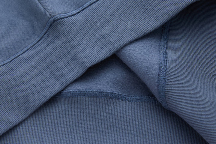 Blue denim hoodie sleeve with ribbed cuff and stitched seam detail