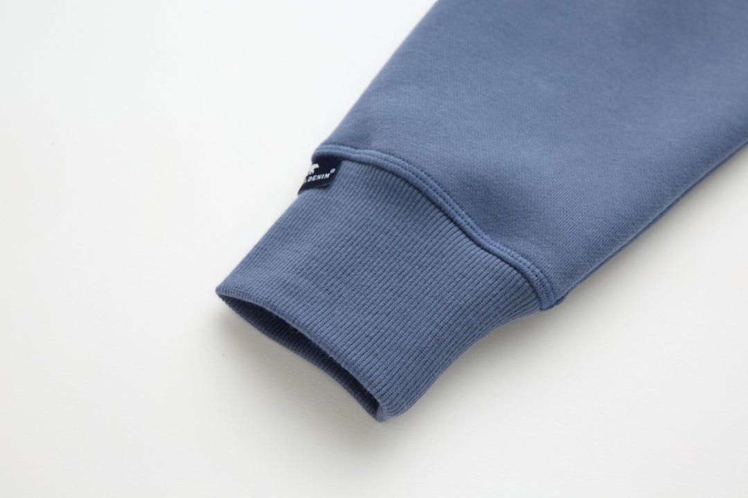 Blue denim hoodie sleeve cuff with ribbed knit hem