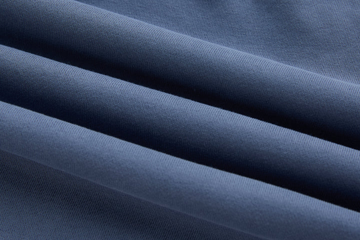Blue denim hoodie fabric close-up with subtle textured weave