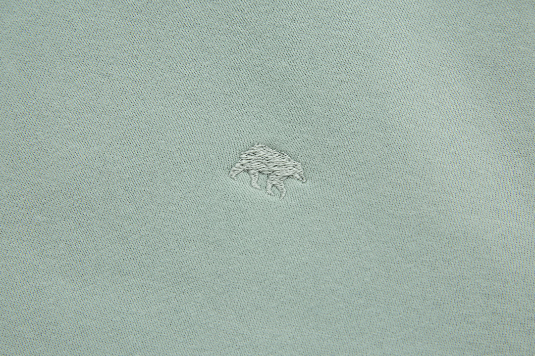 Jade denim hoodie chest logo embroidery, small archer graphic stitched on fabric.