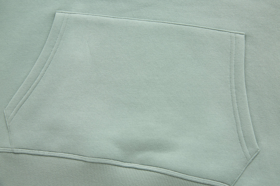 Jade denim hoodie sleeve and hem area, flat lay showing clean topstitching.