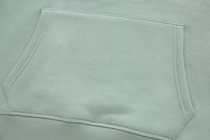 Jade denim hoodie sleeve and hem area, flat lay showing clean topstitching.
