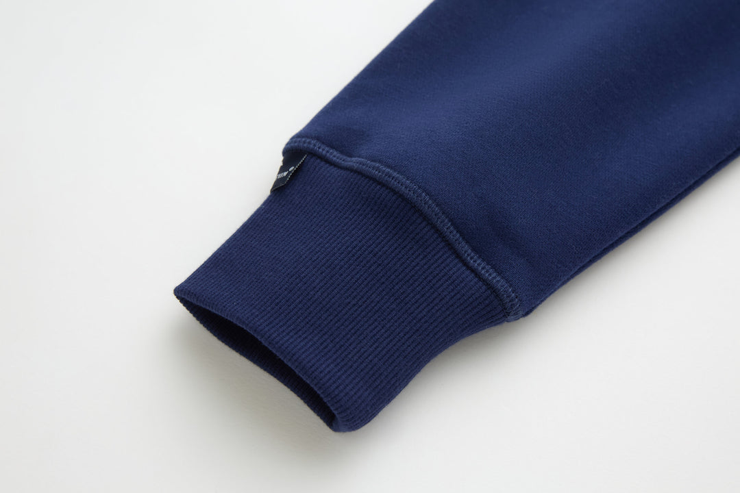 Navy denim hoodie sleeve cuff with ribbed knit hem