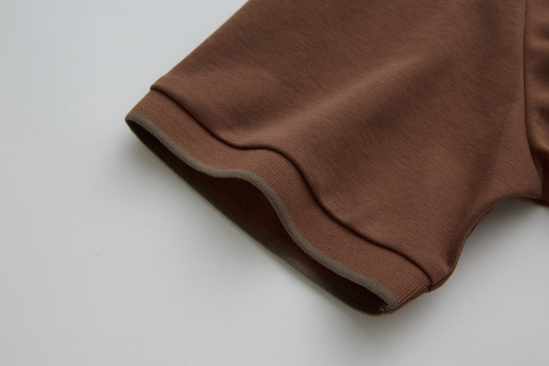 Brown polo shirt sleeve cuff with contrast trim