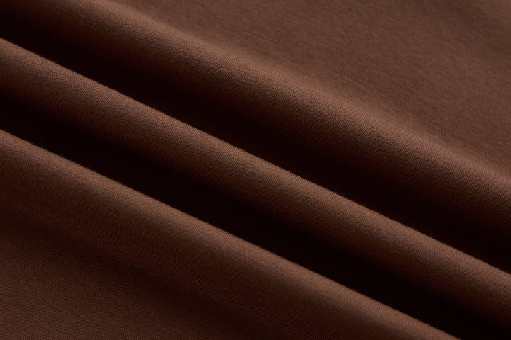 Brown polo shirt fabric close-up with smooth knit texture