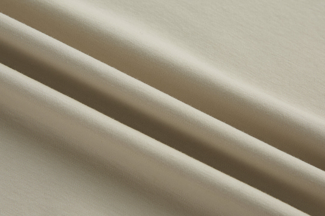Cream polo shirt fabric with fine knit texture
