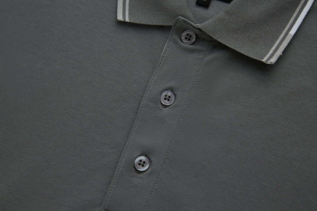 Gray polo shirt front placket with three button closures.