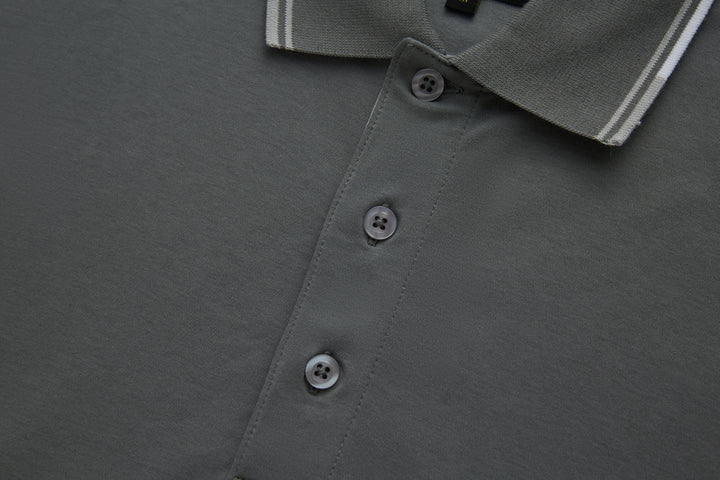 Gray polo shirt front placket with three button closures.